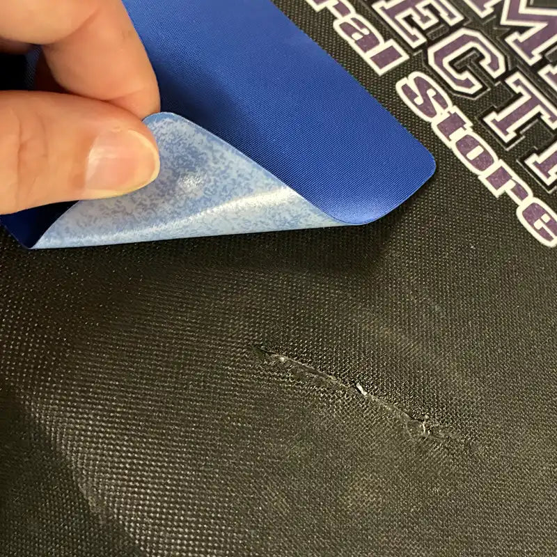 Duffel Repair patch being applied to a black Camp Connection Duffel.