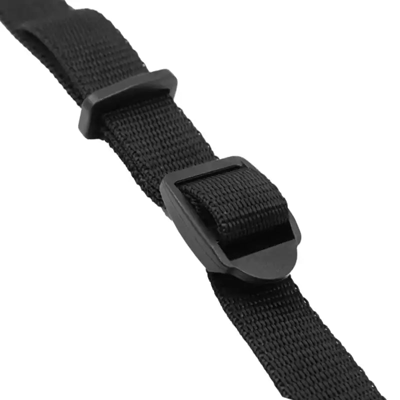 A close-up of a black nylon web belt with a matching matte black plastic quick-release buckle