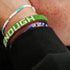 Close-up of a person's wrist wearing multiple beaded bracelets